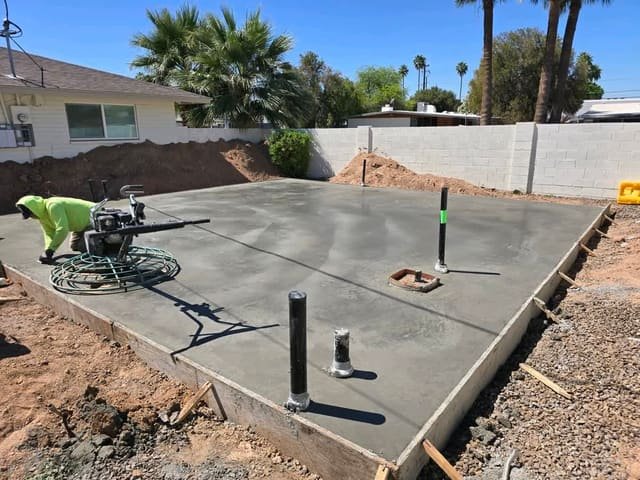 Crew finishing a reinforced concrete slab for a detached ADU
